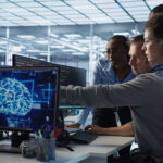 Engineer calling colleagues after finding error in code while doing checkup on server room used for AI workloads