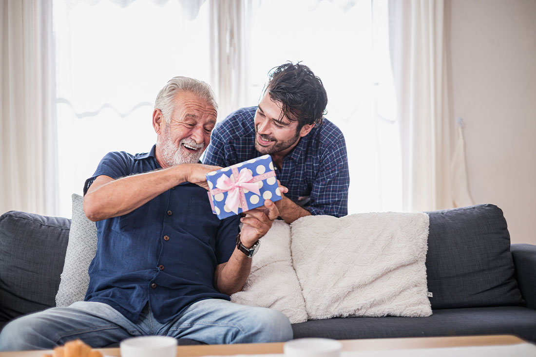 Older man opens the gift box the son gave